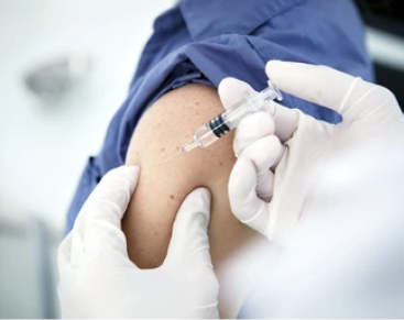 Doctor giving injection to a patient